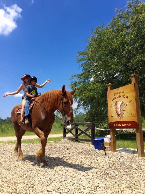 Children enjoying horseback riding at Camp Warrior, a summer camp with outdoor adventures and nature experiences.