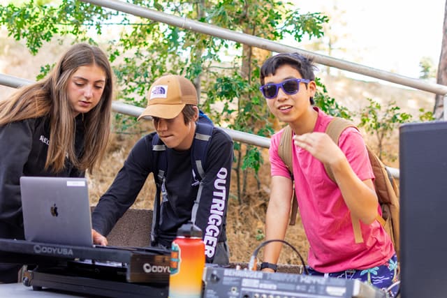 Teens DJing at a summer camp music session. Teens DJing at a summer camp music session.