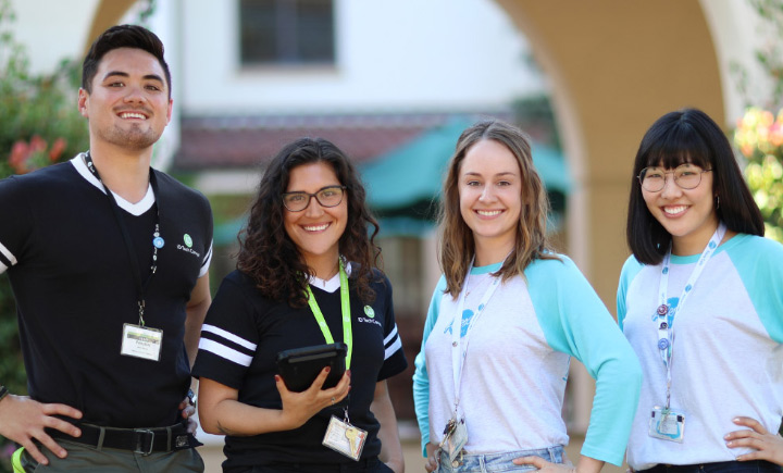 Friendly summer camp counselors smiling outdoors. Friendly summer camp counselors smiling outdoors.