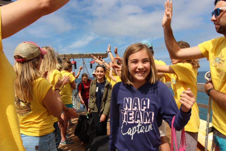 Group of kids and camp leaders enjoying outdoor activities at summer camp with high-fives and smiles. Group of kids and camp leaders enjoying outdoor activities at summer camp with high-fives and smiles.