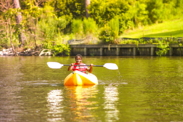 Child kayaking at summer camp, enjoying outdoor adventure activities. Perfect for summer camp directory listings. Child kayaking at summer camp, enjoying outdoor adventure activities. Perfect for summer camp directory listings.