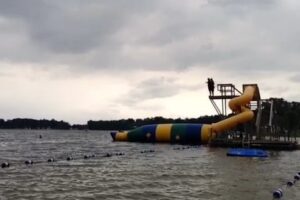 Lake adventure with water slide at summer camp, perfect for outdoor fun and excitement.