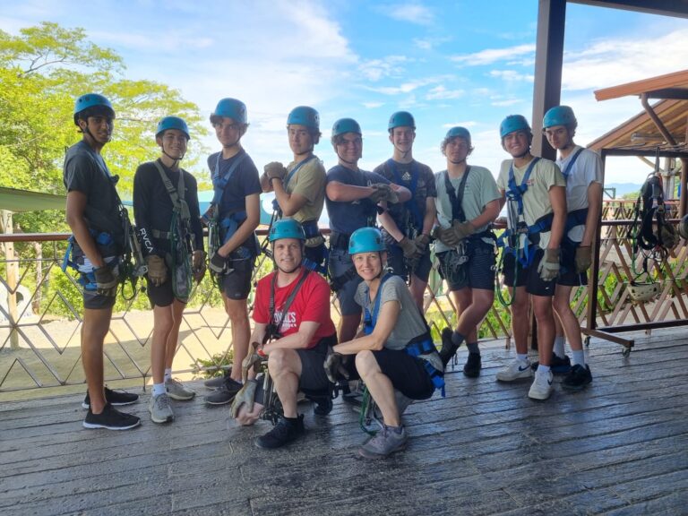 Group of teens in helmets and harnesses ready for zip-lining at summer camp. Group of teens in helmets and harnesses ready for zip-lining at summer camp.