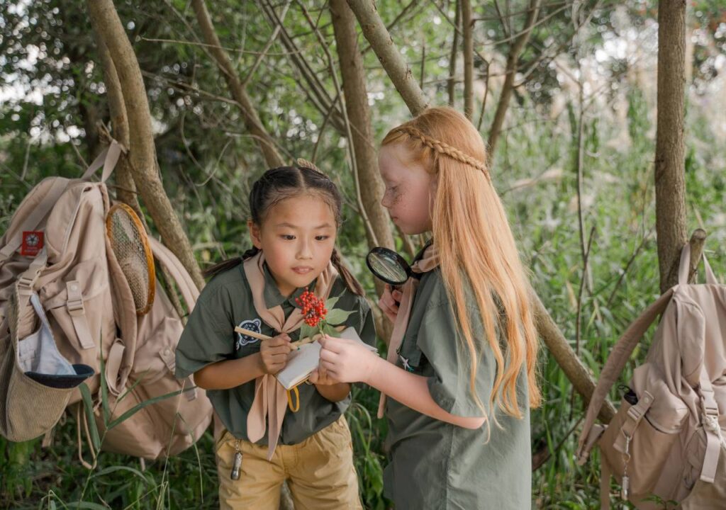 Girls in their camp uniform learning teamwork and socialization as a one of the benefits of summer camp.