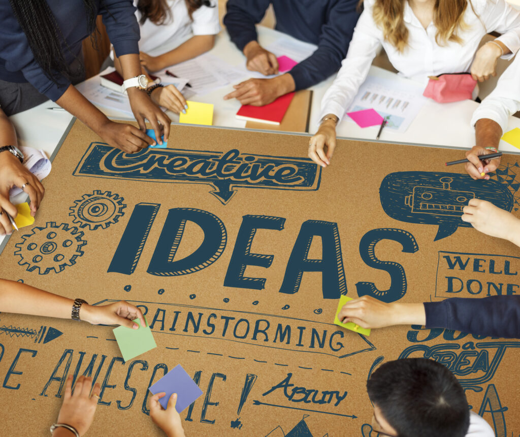 Group brainstorming session with creative ideas at a summer camp planning meeting.