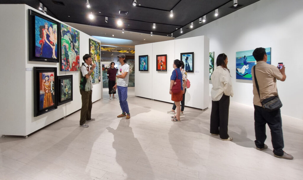 Visitors exploring art in a gallery, ideal for creative summer camp experiences in our directory.