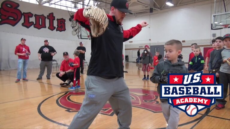 Youth learning baseball skills at U.S. Baseball Academy, indoor summer camp activity.