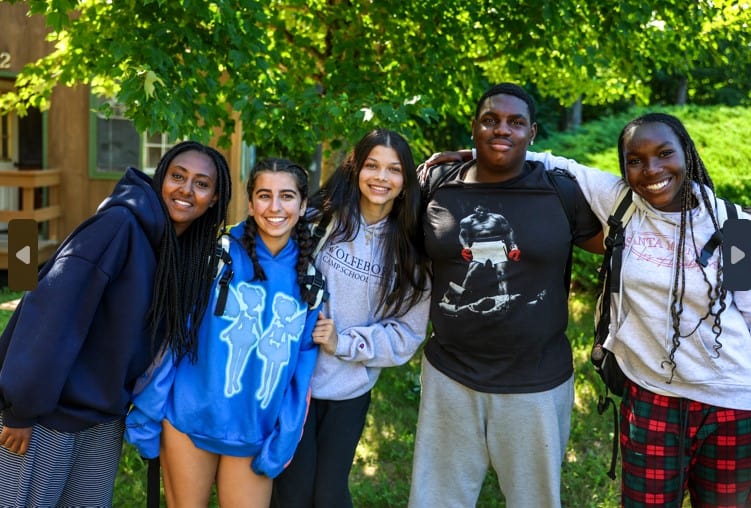 Group of happy summer camp teens enjoying outdoor activities in the sun, smiling under green trees. Group of happy summer camp teens enjoying outdoor activities in the sun, smiling under green trees.