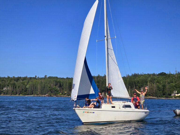 Kids enjoying sailing at summer camp on a sunny day, surrounded by blue waters and lush greenery. Kids enjoying sailing at summer camp on a sunny day, surrounded by blue waters and lush greenery.