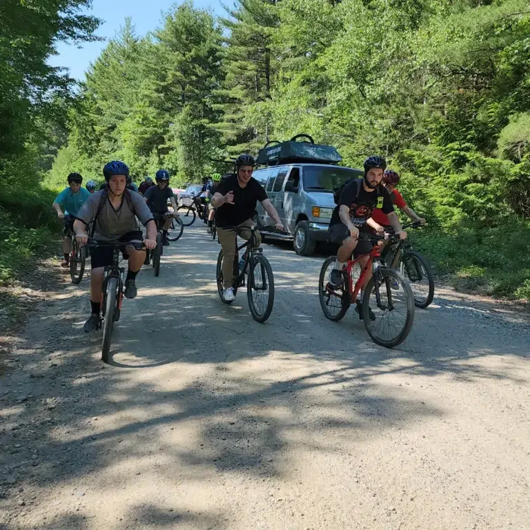 Campers biking through forest trail at summer camp, enjoying outdoor activities and adventure. Campers biking through forest trail at summer camp, enjoying outdoor activities and adventure.