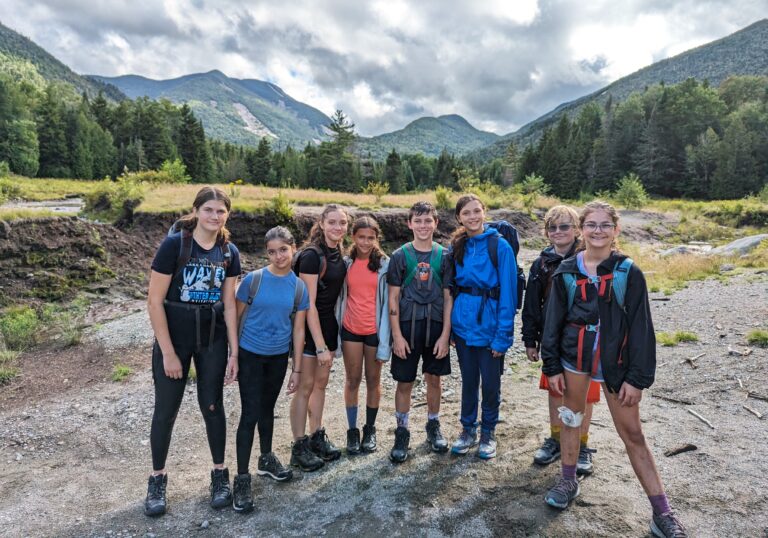 Group of kids hiking in the mountains at a summer camp, showcasing adventure and teamwork. Group of kids hiking in the mountains at a summer camp, showcasing adventure and teamwork.