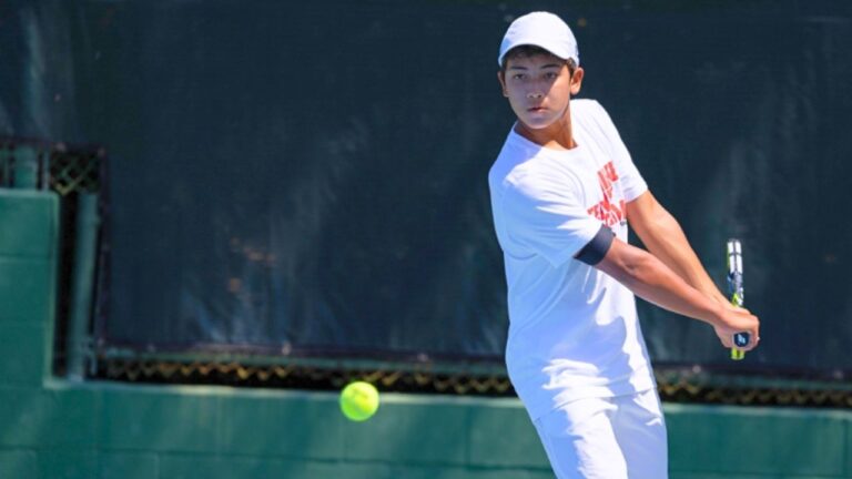 Tennis player preparing a backhand swing at summer camp. Explore top-rated tennis camps for youth. Tennis player preparing a backhand swing at summer camp. Explore top-rated tennis camps for youth.