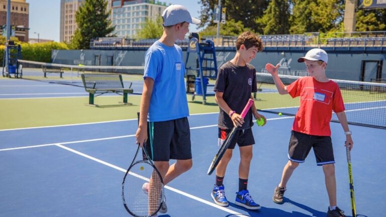 Kids playing tennis at summer camp, building skills and friendships on the court. Kids playing tennis at summer camp, building skills and friendships on the court.