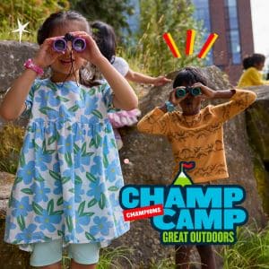 Kids explore with binoculars at Champ Camp, enjoying outdoor adventure activities. Perfect summer camp experience!