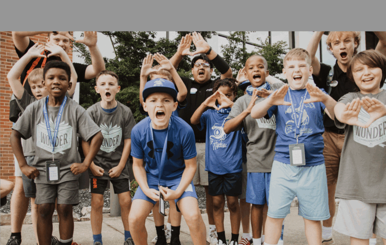 Group of kids and counselors excitedly posing outside at a summer camp, showing enthusiasm and teamwork. Group of kids and counselors excitedly posing outside at a summer camp, showing enthusiasm and teamwork.