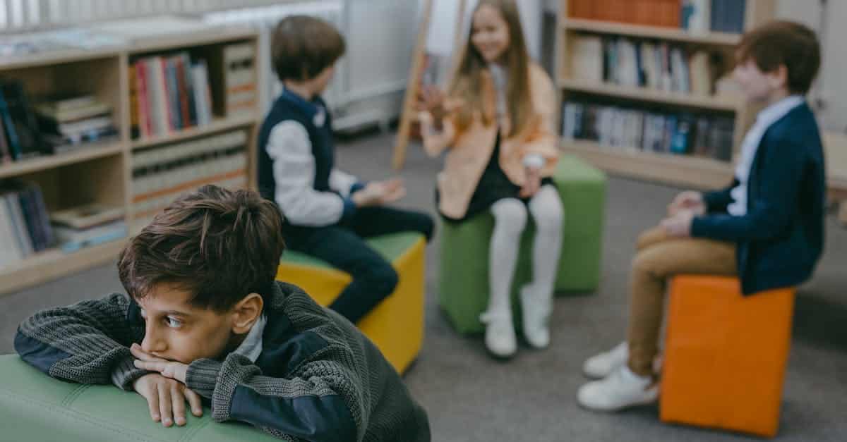 Child with separation anxiety, indoors at summer camp, empasizing the importance of proper separation anxiety relief techniques.