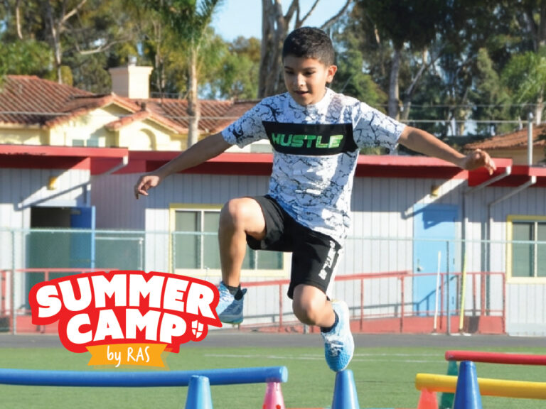 Child jumping over colorful obstacle course cones during outdoor summer camp activity on sports field, Summer Camp by RAS logo Child jumping over colorful obstacle course cones during outdoor summer camp activity on sports field, Summer Camp by RAS logo