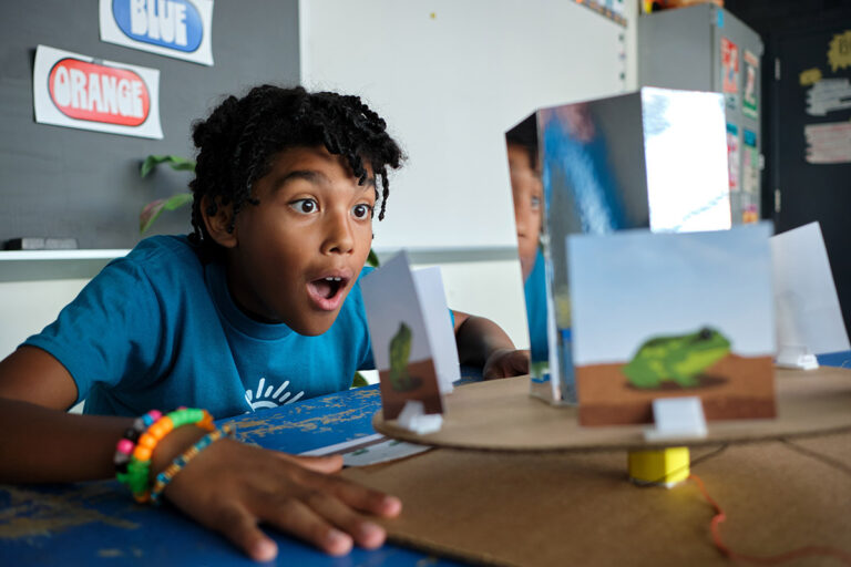 Excited boy engaging in a hands-on science project at summer camp, exploring creativity and learning through play. Excited boy engaging in a hands-on science project at summer camp, exploring creativity and learning through play.