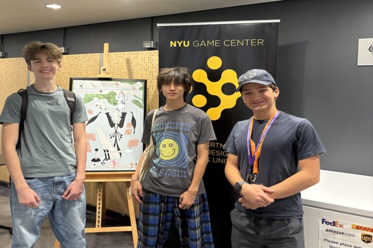 Three teen summer campers smiling at NYU Game Center game-design showcase, posing in front of poster and banner Three teen summer campers smiling at NYU Game Center game-design showcase, posing in front of poster and banner