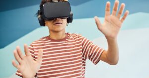 Teen enjoying virtual reality at a summer camp. Explore tech activities at our summer camp directory.